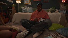 Three ethnically diverse male and female students sitting on floor in dorm room, enjoying studying together - Powered by Shutterstock - Get 15% off with code: PIKWIZARD15