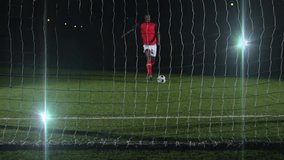 Preparing to kick ball, soccer player in red uniform aiming at goal net. athlete, sports, team, competition, action, footwear - Powered by Shutterstock - Get 15% off with code: PIKWIZARD15