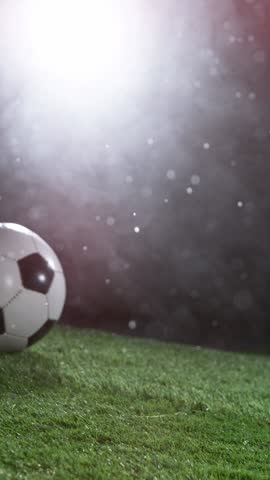 Close-up of Football Player Kicking Soccer Ball, Rainy Weather, Fog in Background. Super Slow Motion at 1000 fps. Filmed on High Speed Cinematic Camera at 1000 fps.