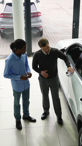 Car Salesman Discussing Vehicle Options with Potential Buyer