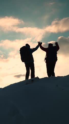 Travelers climb one after another on rock Climbers silhouettes stretch their hands to each other climbing to top of hill. Teamwork of business people. Go towards your goal. Team of businessmen victory