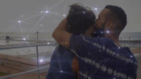 Couple embracing on balcony with network of connections animation overlay. Technology, romance, virtual, digital, communication, futuristic - Powered by Shutterstock - Get 15% off with code: PIKWIZARD15