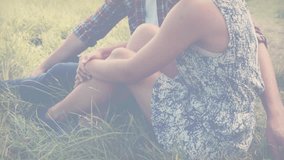 Sitting in field, couple with autism awareness puzzle heart animation overlay. diversity, acceptance, love, connection, inclusivity, compassion - Powered by Shutterstock - Get 15% off with code: PIKWIZARD15