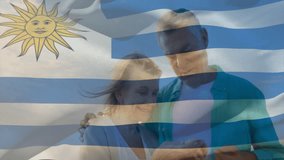 Embracing on beach, elderly couple with Uruguay flag animation overlay. Senior, romance, vacation, travel, celebrate, patriotism - Powered by Shutterstock - Get 15% off with code: PIKWIZARD15