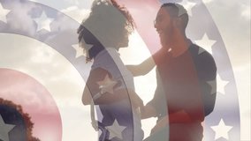 Embracing on bicycle, couple with patriotic star and stripes animation overlay. Patriotism, cycling, romance, celebration, freedom, love - Powered by Shutterstock - Get 15% off with code: PIKWIZARD15