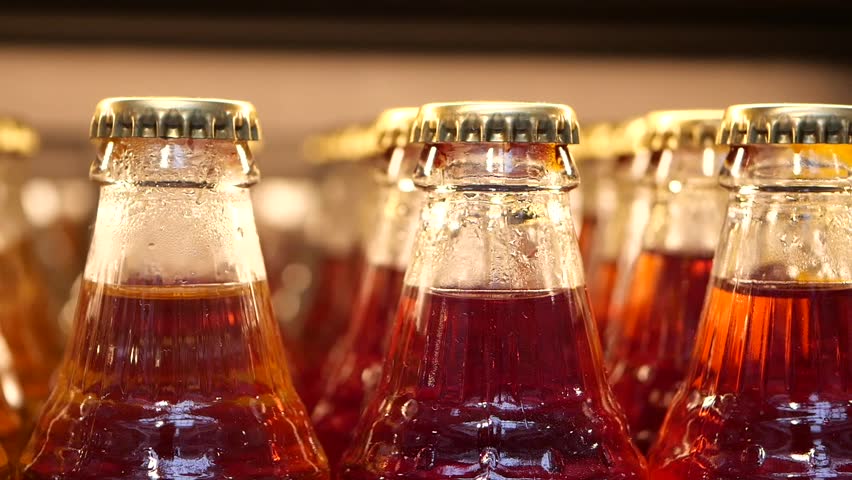 Refreshing drinks lined up in a storefront cooler at a local market
