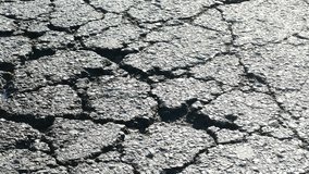 Cracked asphalt surface shows signs of wear and tear over time - Powered by Shutterstock - Get 15% off with code: PIKWIZARD15