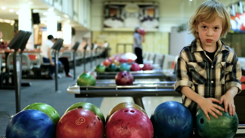 little boy choosing bowling ball