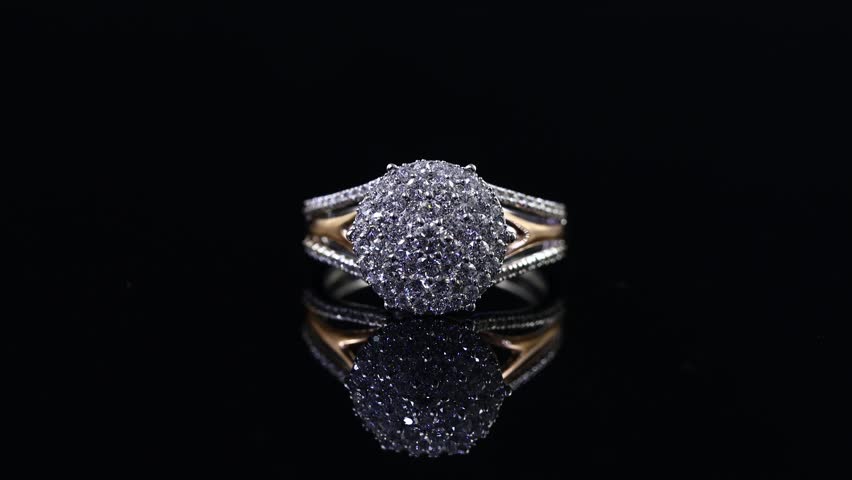 beautiful bright and shine diamond ring on the mirror and black background rotating