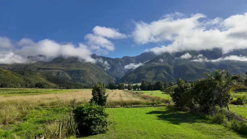 Bright, sunny day on a farm in Swellendam, South Africa, with clouds moving over the Langeberg mountains.