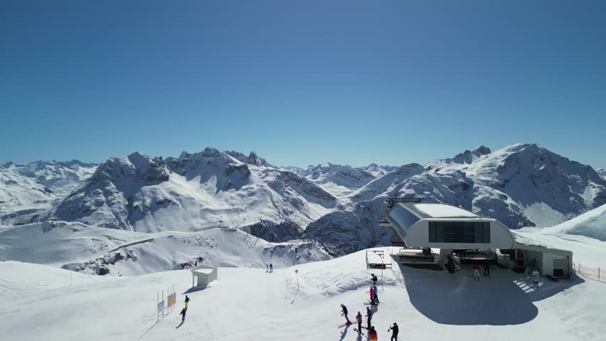 Epic drone footage of snow capped peaks in Austrian ski resort of Lech on a beautiful sunny clear blue day