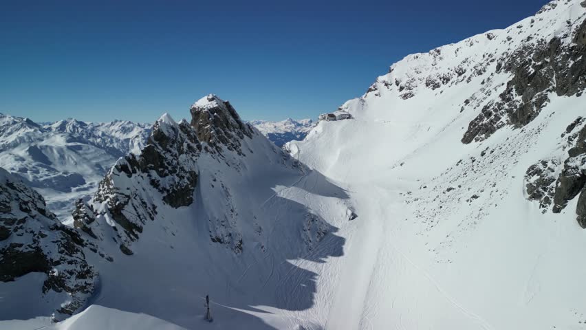 Epic drone footage of snow capped peaks in Austrian ski resort of St Anton On a beautiful sunny clear blue day