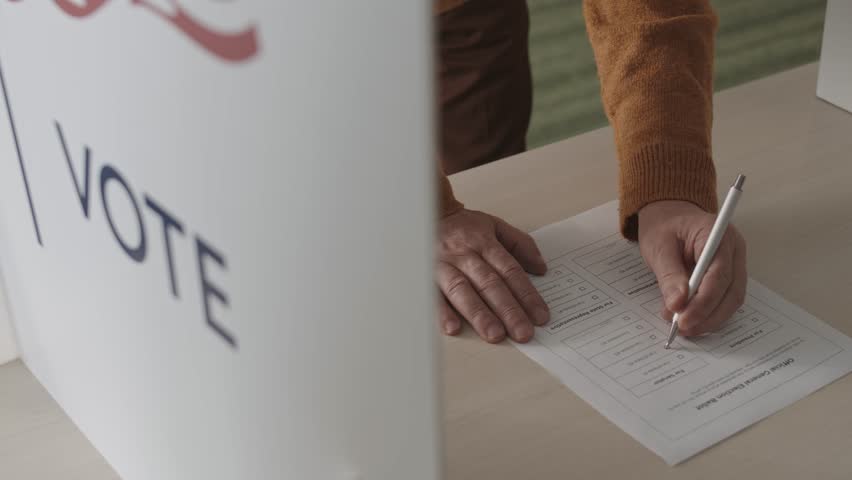 Close-Up of a Person Marking a Ballot Paper with a Tick During an Election