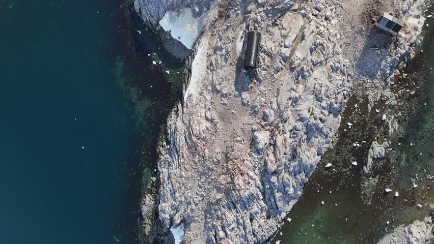 Rocky coastal. Iceberg scenery landscape scenery Arctic Antarctica beautiful mountains nature winter tourism travel ice ocean sea water. Glacier melting ecology concept. Antarctic Aerial drone view 