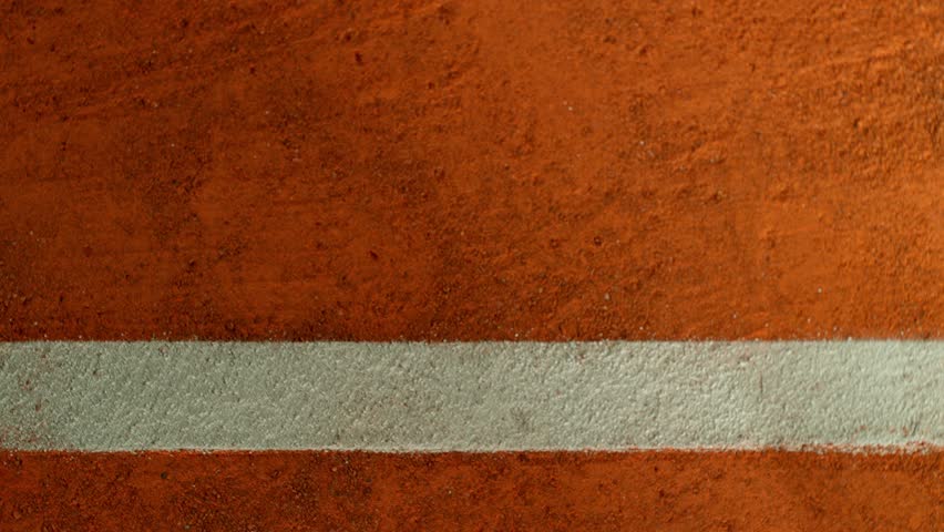 Super Slow Motion Detail Shot of Tennis Ball Hitting a Clay Court . Filmed on High Speed Cinematic Camera at 1000 fps