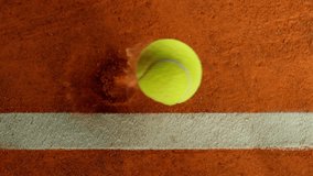 Super Slow Motion Detail Shot of Tennis Ball Hitting a Clay Court . Filmed on High Speed Cinematic Camera at 1000 fps - Powered by Shutterstock - Get 15% off with code: PIKWIZARD15