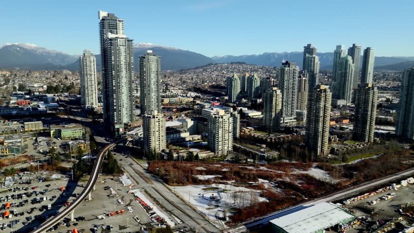 Aerial View Of High-rise Buildings, Traffic and Elevated Railroad Tracks In North Burnaby, Canada.