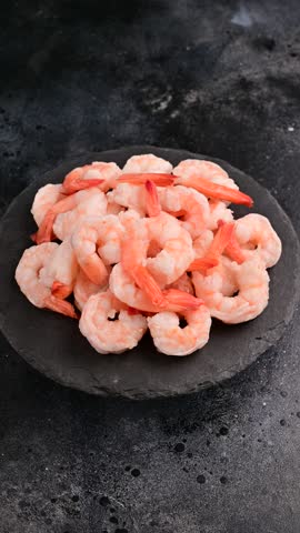 A plate of prawns. The shrimp are arranged in a way that they are not overlapping each other.