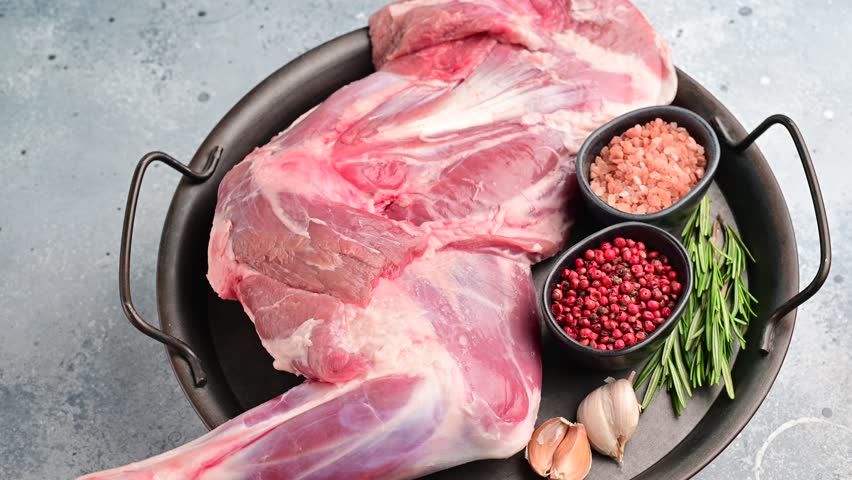 Whole fresh lamb mutton shoulder, inviting you to prepare a delicious roast that will impress your guests.  white background. top view.