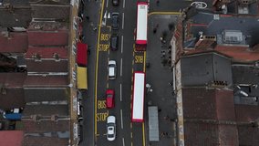 Top-down drone view of London East End High Street with cars, buses and shops - Powered by Shutterstock - Get 15% off with code: PIKWIZARD15