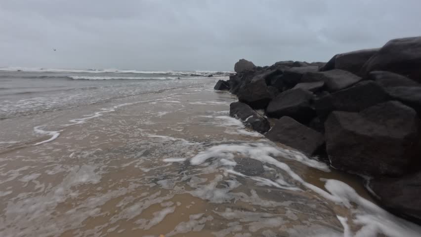 Rocky Shore And Foamy Waves At Currumbin Beach In Queensland, Australia. - handheld shot
