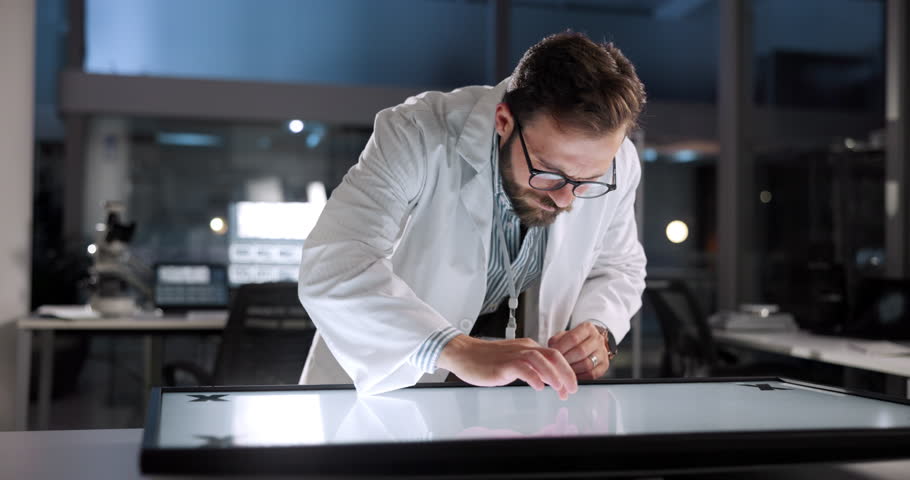 Man, scientist or interactive display in lab for science breakthrough, clinical trial or discovery. Night, medical study and checking results on technology for vaccine research, cure or development