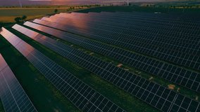Windmill turbines generating green energy electric. Green energy reduce carbon emissions and makes earth cleaner and more ecological. Solar panels park and wind turbines at sunset. - Powered by Shutterstock - Get 15% off with code: PIKWIZARD15