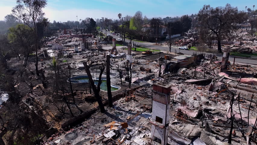 A drone footage capturing the fire Aftermath of Pacific Palisades Neighborhood, showcasing the debris of damaged homes in Los Angeles, California