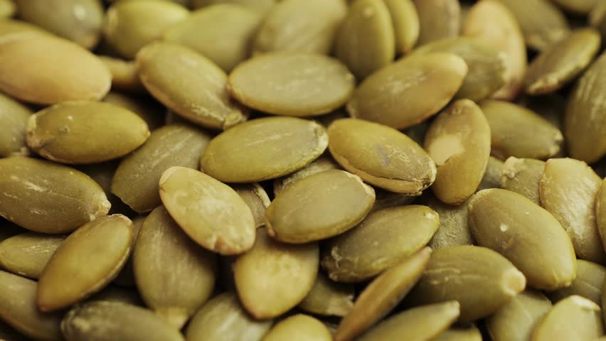 Healthy organic pumpkin seeds close-up. Healthy vegetarian snack.