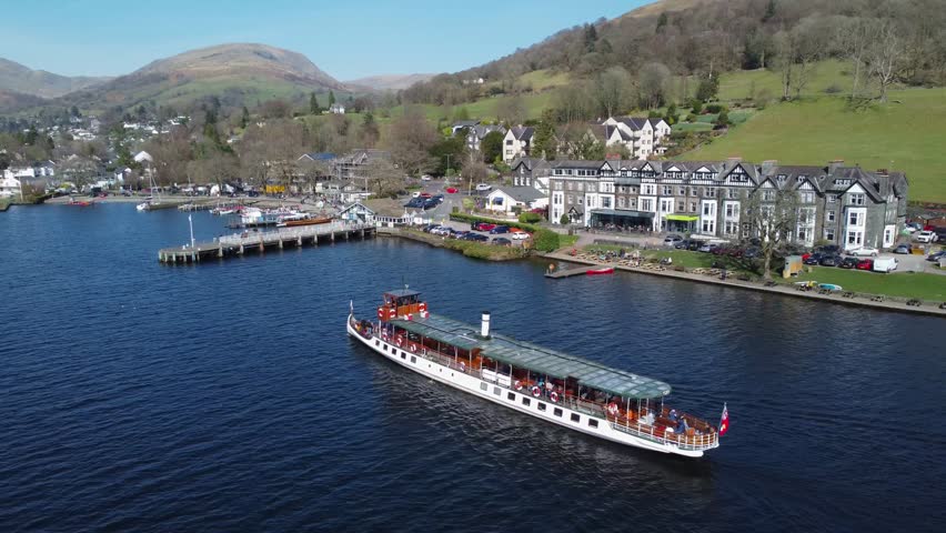 Boat on Windermere Lake near piers of Ambleside