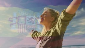 In sunny weather, woman at beach with Spanish flag animation overlay. holiday, sunshine, summer, travel, relaxation, patriotism - Powered by Shutterstock - Get 15% off with code: PIKWIZARD15