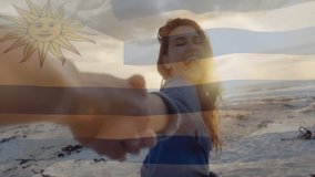 Holding hands on beach, person with Uruguay flag animation overlay in background. Travel, vacation, friendship, unity, coast, scenic - Powered by Shutterstock - Get 15% off with code: PIKWIZARD15