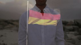 Standing outdoors, man with German flag animation overlay in background. Patriotism, celebration, national pride, festival, unity, sports fan - Powered by Shutterstock - Get 15% off with code: PIKWIZARD15