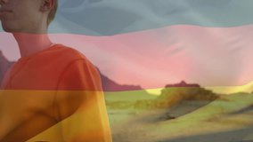 Wearing yellow shirt, man with German flag overlay in desert animation landscape. patriotism, virtual, digital art - Powered by Shutterstock - Get 15% off with code: PIKWIZARD15