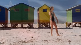 On sandy beach, child doing cartwheel near colorful beach huts, enjoying animation. summer, children, seaside, holiday, seaside activities, fun - Powered by Shutterstock - Get 15% off with code: PIKWIZARD15