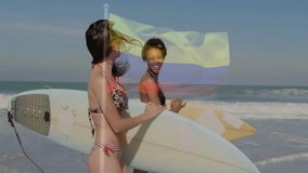 Two women with surfboards on beach, Colombian flag animation over scene. Surfing, ocean, friends, adventure, travel, lifestyle - Powered by Shutterstock - Get 15% off with code: PIKWIZARD15