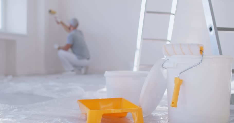 Professional painting, painter team service, construction workers, professional service men wearing uniform doing preparation, finishing tasks for room repair, color walls in apartment flat renovation