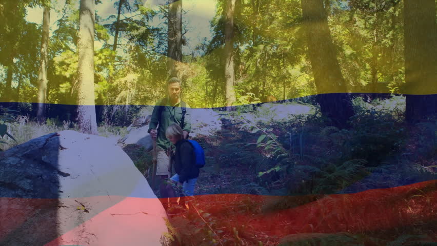 Hiking through lush forest, people carrying Colombian flag with animation overlay. adventure, trekking, outdoors, patriotism, nature, exploration