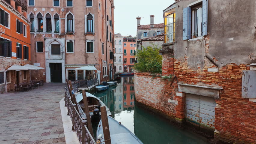 Stunning view of one of the famous canals in Venice, Italy along with quirky buildings, powerful reflections and vivid green water. Venice is an archipelago of 126 islands linked by 472 bridges
