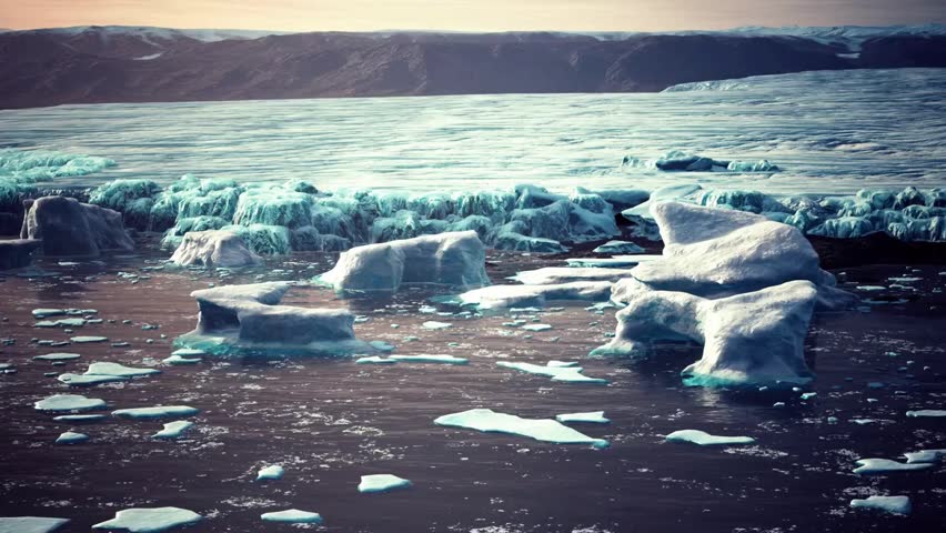 Icebergs and ice floes float serenely in the sea near Iceland, creating a breathtaking, frozen landscape against the backdrop of rugged mountains.
