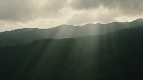 Sun Rays and Dark Mountains Sunset Over a Ridge, Crepuscular Rays aka God Rays with Dramatic Clouds and Sky in Moody Atmospheric Dark Close Up Landscape Scene in the Himalayas in Nepal - Powered by Shutterstock - Get 15% off with code: PIKWIZARD15