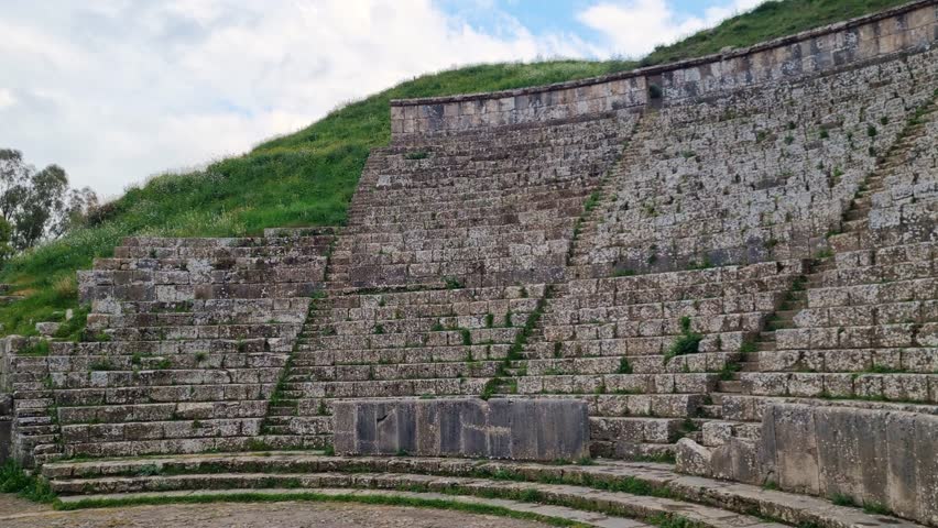 Shot of the well-preserved small amphitheater in the ancient Roman city of Djemila, Algeria, on an overcast spring day