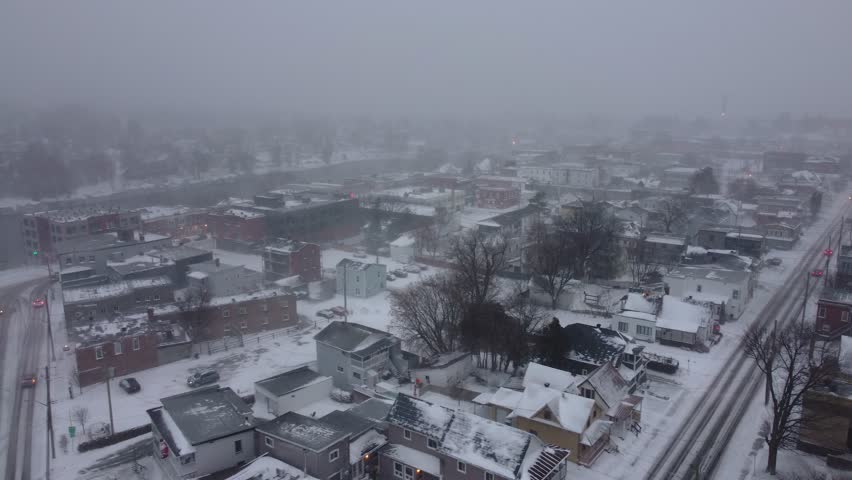 Snow-covered town in Orford, Québec, captured from an aerial view on a foggy winter day