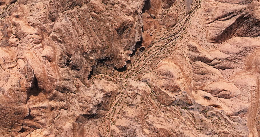 Aerial view of a desert landscape with canyons and rock formations