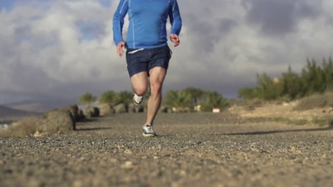 Man jogging in on dirt track, super slow motion, shot at 240fps
