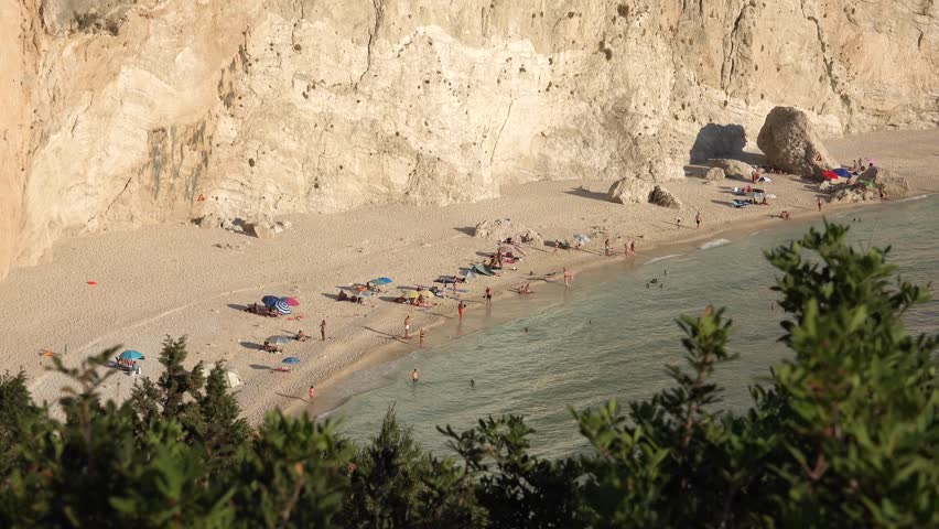 Greece Beach with Blue Waves in Sunset, People on Seashore, Seascape View in Summer 4K