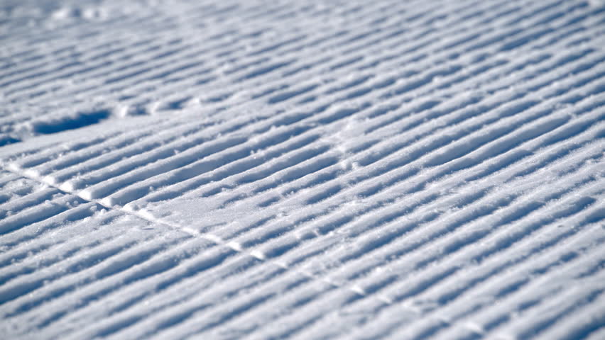 Close up of lines on the snow prepared for skiing on the mountain in the Dolomites, Italy