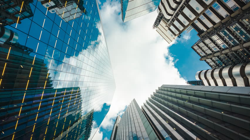 Bottom-up rotating timelapse of important and futuristic skyscrapers in the financial center of a major city