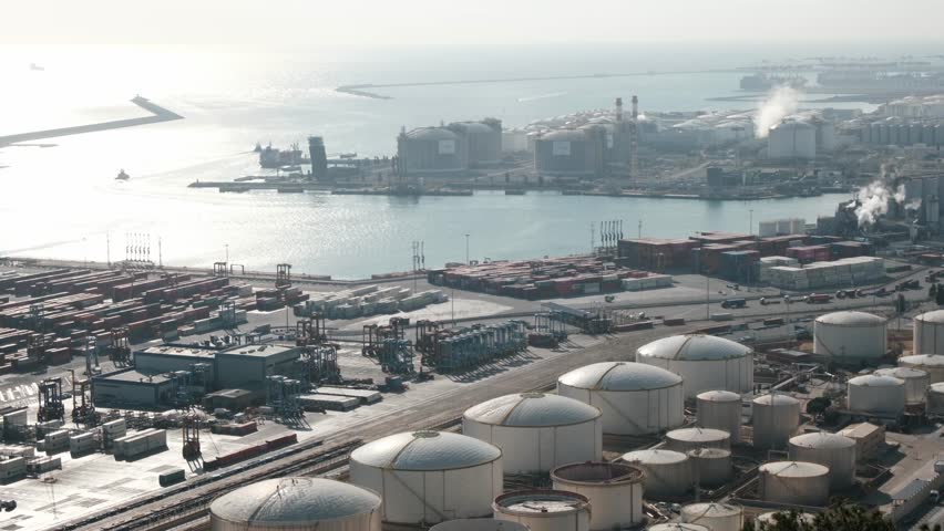 Barcelona, Spain, 5 January 2024: View from Montjuic Mountain to industrial port Zona Franca. busy scene with containers being loaded and unloaded, showcase logistics and shipping activities in harbor