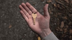 Golden key to a new house or flat lies in the palm of a man's hand. Close-up  - Powered by Shutterstock - Get 15% off with code: PIKWIZARD15